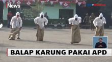 Gunakan APD Lengkap, Prajurit TNI Ikuti Lomba Balap Karung di Surabaya