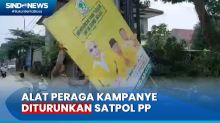 Satpol PP Turunkan  Spanduk Kampanye, Rusak Keindahan Kota Depok