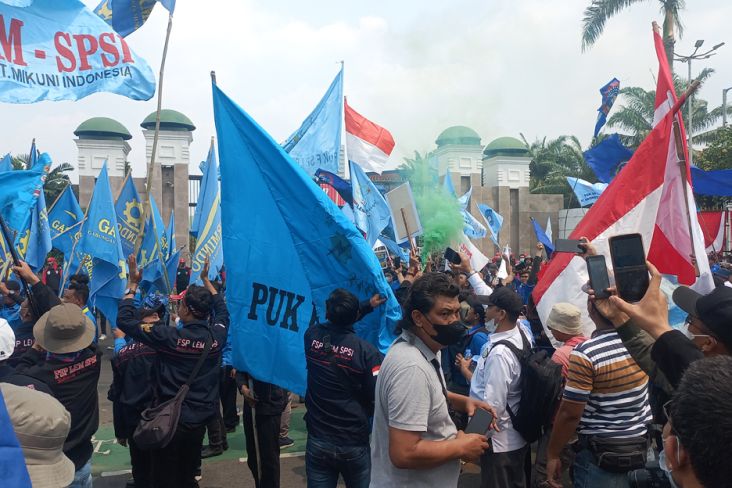 Massa Buruh Nyalakan Flare dan Kibarkan Bendera di Depan Gedung DPR-MPR