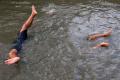 Tak Hiraukan Air Keruh, Anak-anak Ini Asik Bermain di Sungai Surabaya